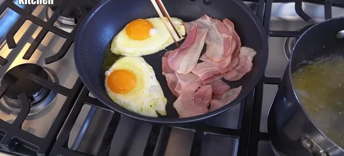 Fry bacon and sunny-side up eggs simultaneously.