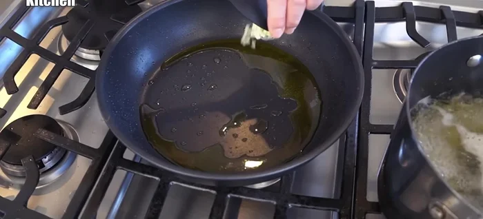 Add olive oil to the frying pan, then add the chopped garlic. Stir until fragrant.