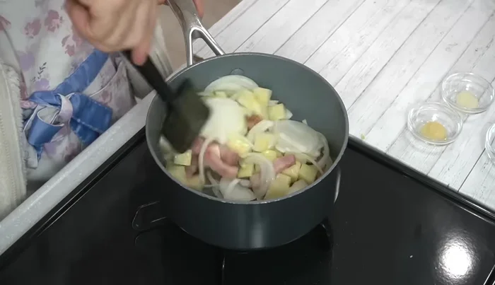 Add potatoes and onions to the pot and fry until slightly browned.