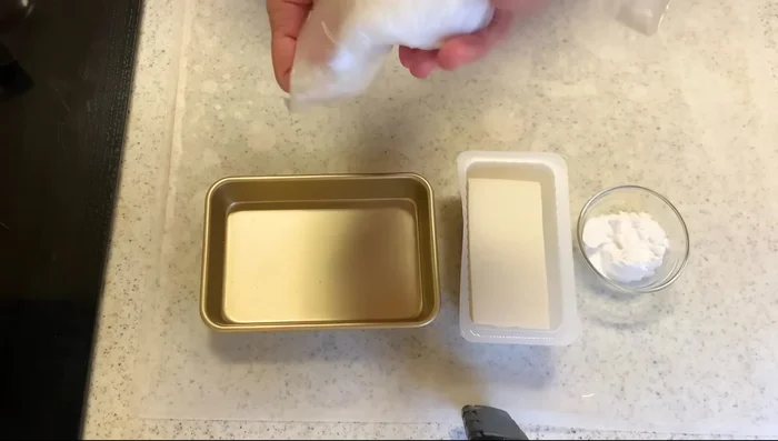 Mash half a block of tofu in a plastic bag. If using silken tofu, add potato starch at this stage.