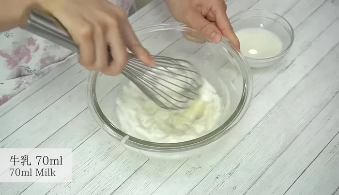 Add half the warm milk, mix well, then add the remaining half and mix.