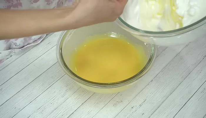 Gently fold the meringue into the egg yolk batter in several additions, mixing until no streaks remain.