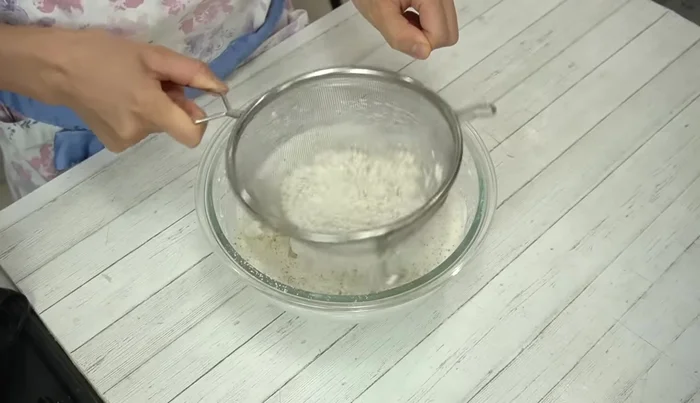 Gently fold the dry ingredients into the meringue using a rubber spatula. Begin macaronage.