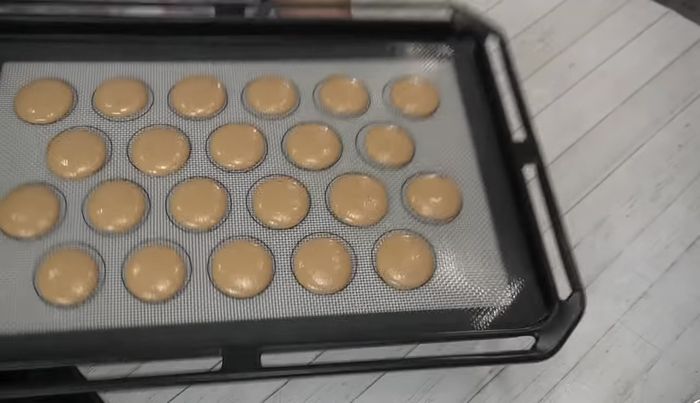 Tap the baking sheet to release air bubbles and use a toothpick to remove any surface bubbles.