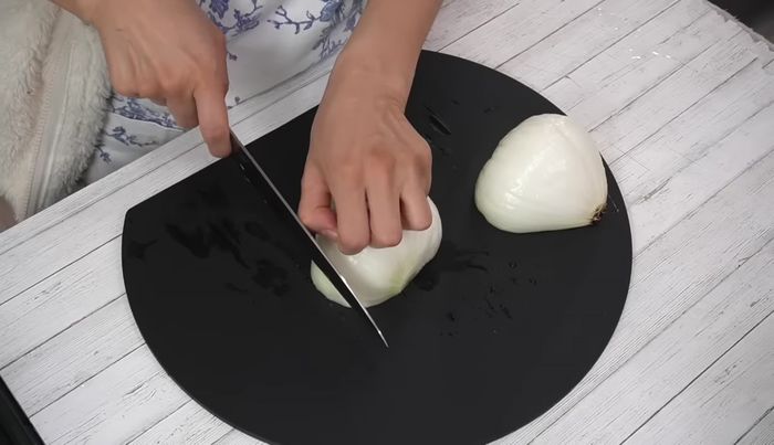 Cut the onion in half, then slice along the fibers to your desired thickness (about the thickness of a coin). Remove the core.