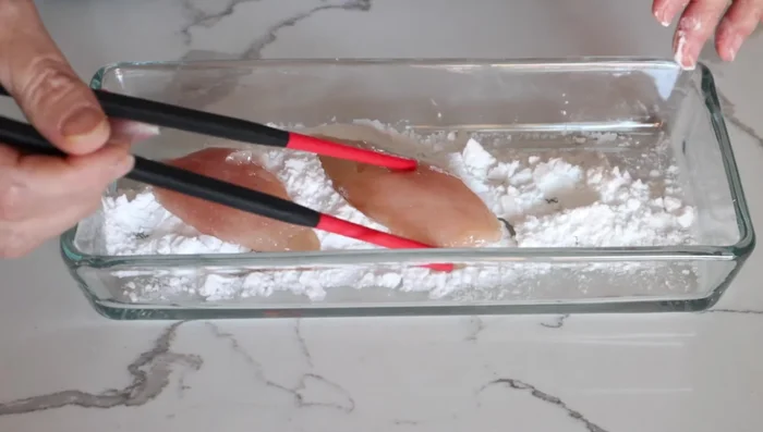 Lightly coat chicken pieces with potato starch.