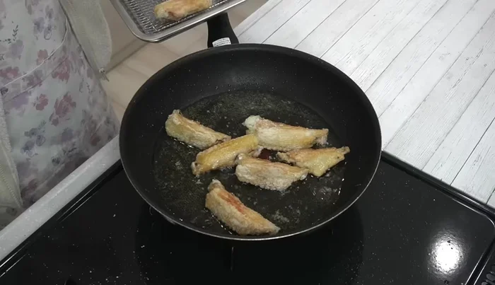 Remove chicken wings from pan and let drain on a wire rack or paper towels for about 3 minutes.