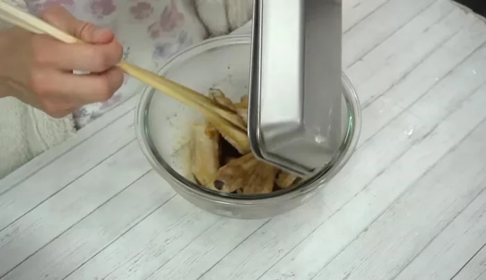 Add the fried chicken wings to the sauce and toss to coat thoroughly.