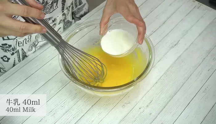 Add milk to the egg yolk mixture and mix well.