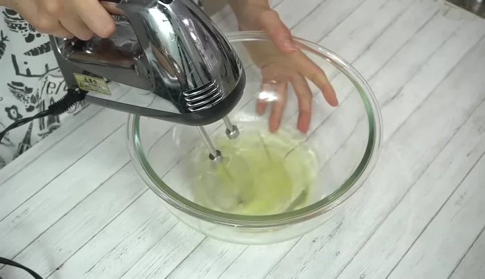 Whip egg whites on low speed for 30 seconds to create coarse bubbles. Add granulated sugar and beat on high speed for 1 minute, then low speed for 1 minute until glossy and stiff peaks form.
