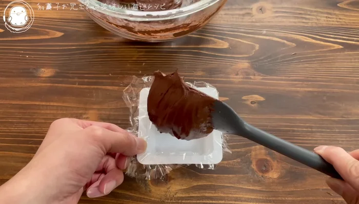 Pour the chocolate mixture into the prepared container.