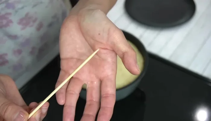 After 10 minutes, check doneness with a bamboo skewer. If still raw, carefully loosen the edges and flip the cake. Return to the pan, uncooked side down, cover, and bake for another 5 minutes on very low heat.