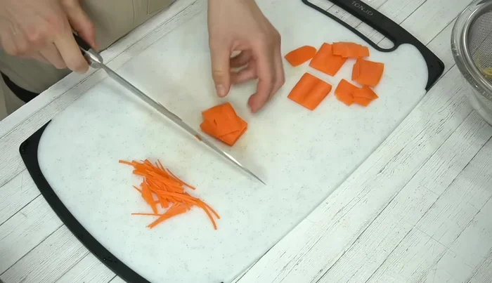 Peel and thinly slice the carrots, then cut them into thin strips.