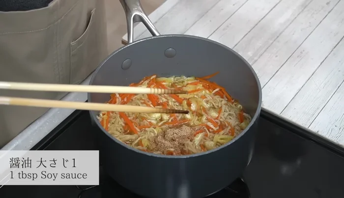 Once boiling, add dashi and soy sauce. Mix well.