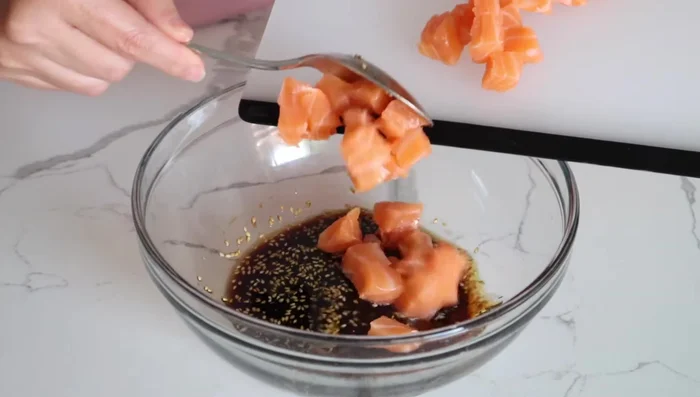 Add the salmon, avocado, and green onions to the bowl with the sauce. Toss to combine.