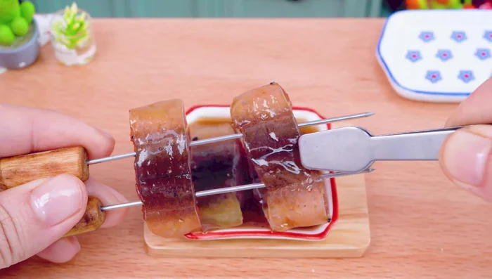 Prepare the eel: Skewer the eel.