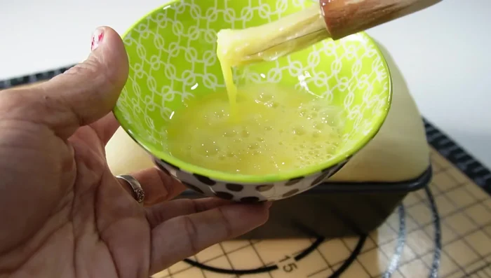 Egg wash: Beat an egg (or use milk/cream) and brush it over the risen dough.