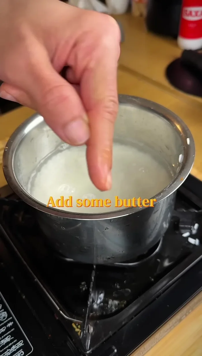 Cook the soaked rice with water and butter oil in a pan. Start on high flame, then reduce heat and simmer until water evaporates.