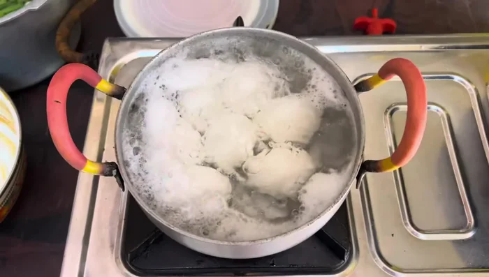 Boil the mixture well. Separately, boil the eggs and chillies.
