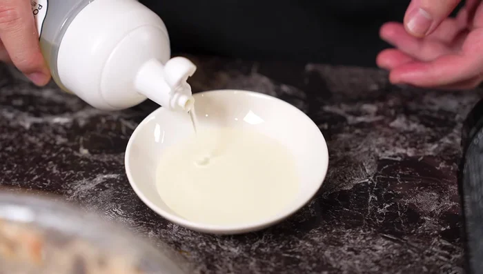 Lightly oil your hands. Shape the mixture into small balls (approximately 5). Gently place them into a frying pan.