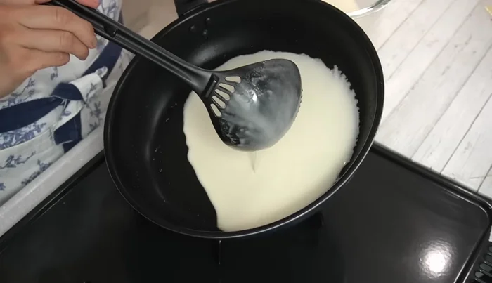 Cook the dough: Pour the dough into the hot pan and quickly rotate the pan to spread it thinly. Cook until lightly browned on one side (about 1.5 minutes).