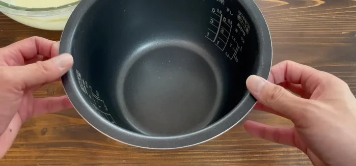 Grease the rice cooker with butter or oil.