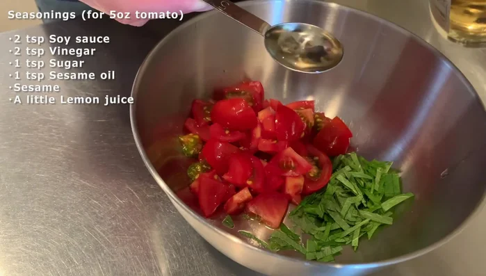 Combine salad ingredients: Combine shiso, tomatoes, vinegar, soy sauce, sesame oil, sugar, sesame seeds and lemon juice in a bowl.