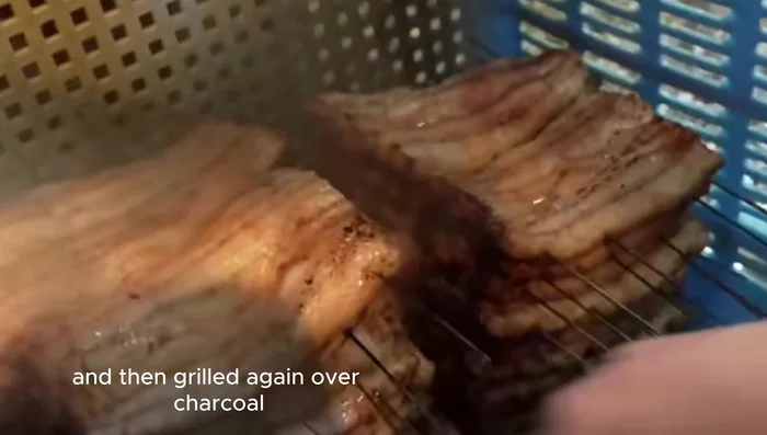 Grill again over charcoal, repeating this process several times until the sauce becomes thick and glossy, and the eel is perfectly caramelized and fragrant.