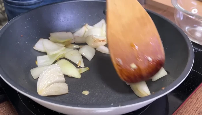 In the same pan, sauté onions until translucent. Add carrots and potatoes, stir-fry briefly.