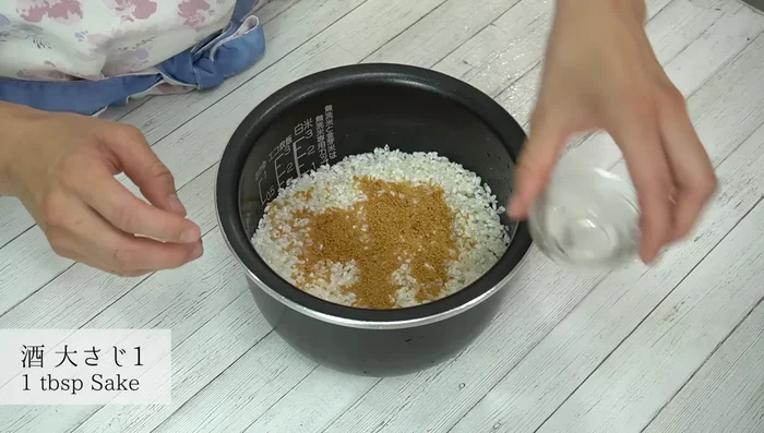 In the rice cooker, combine drained rice with beef broth, mirin, and sake. Season with salt and pepper. [371.84]