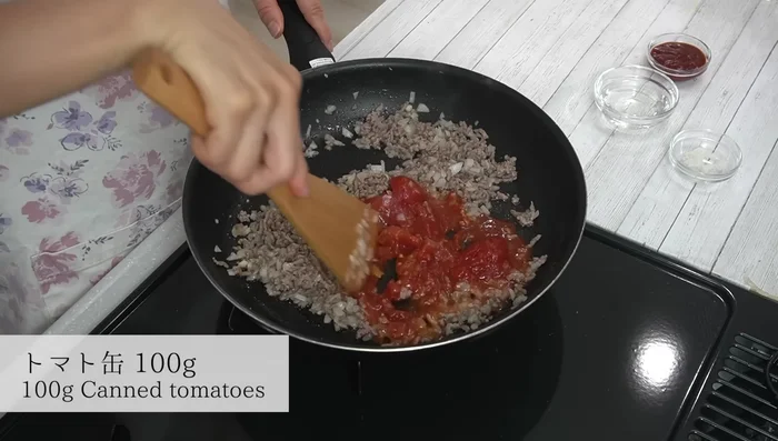 Add canned tomatoes, crumble and fry thoroughly to concentrate the flavor.