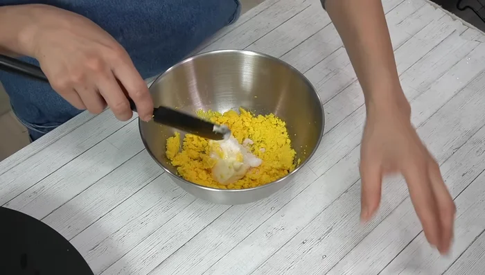 Add mayonnaise, sugar, salt, and vinegar to the mashed yolks. Mix thoroughly until creamy.
