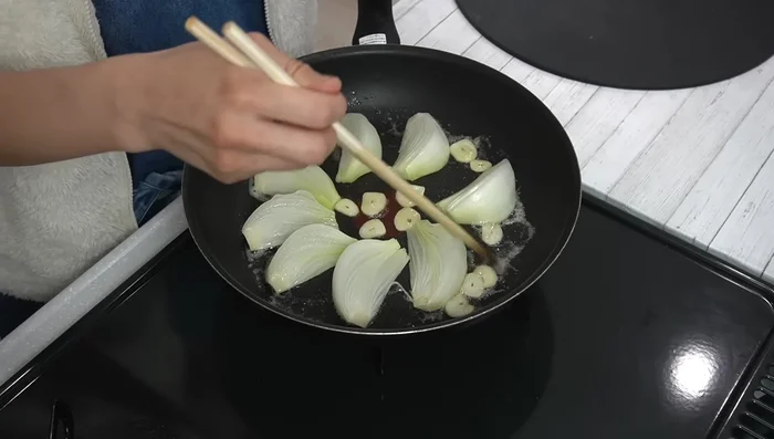 Cook the onions until they start to brown on both sides, flipping them carefully.