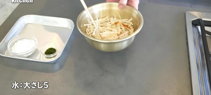 Add water to the mixture and quickly stir to combine. The water acts as a binder.