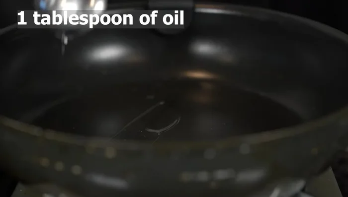 Heat 1 tbsp of oil in a frying pan over medium heat. Sauté the minced garlic for about 30 seconds.