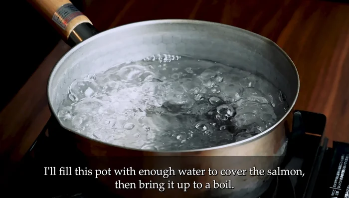 Bring enough water to cover salmon to a boil in a pot. Reduce heat to low, simmer, and gently cook the salmon for 5 minutes.