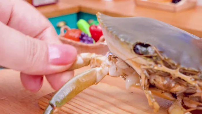Separate crab legs and boil them in water.