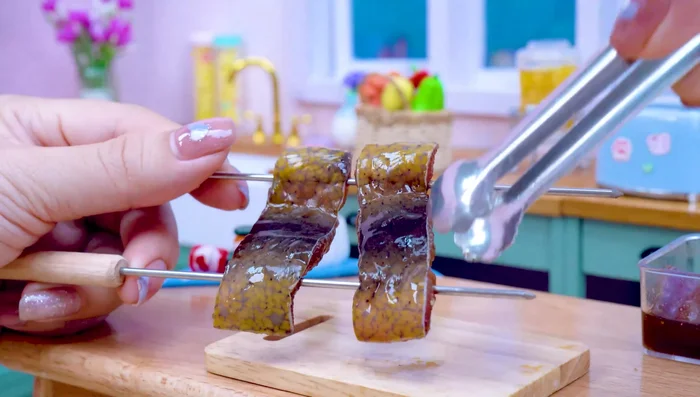 Grill the Eel: Thread the eel onto skewers and grill, brushing with additional ane sauce.