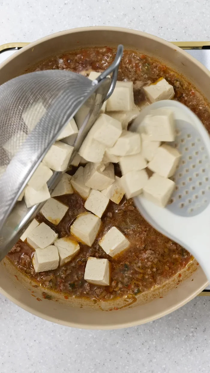 Add the prepared tofu to the simmering broth.