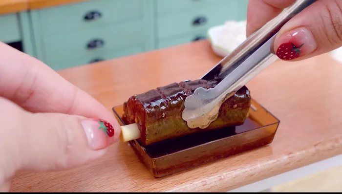 Stuff the eel: Place the lemongrass inside the eel's belly. Pour the vegetable mixture into the eel.