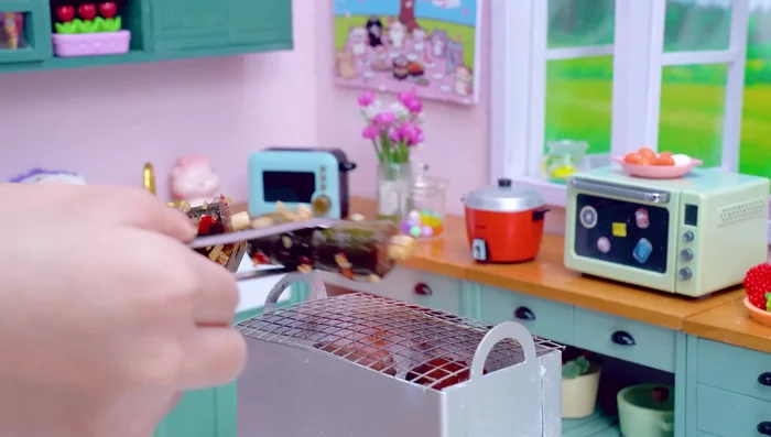Grill the eel: Place the eel on the charcoal grill. Flip it over and brush with more sesame oil.