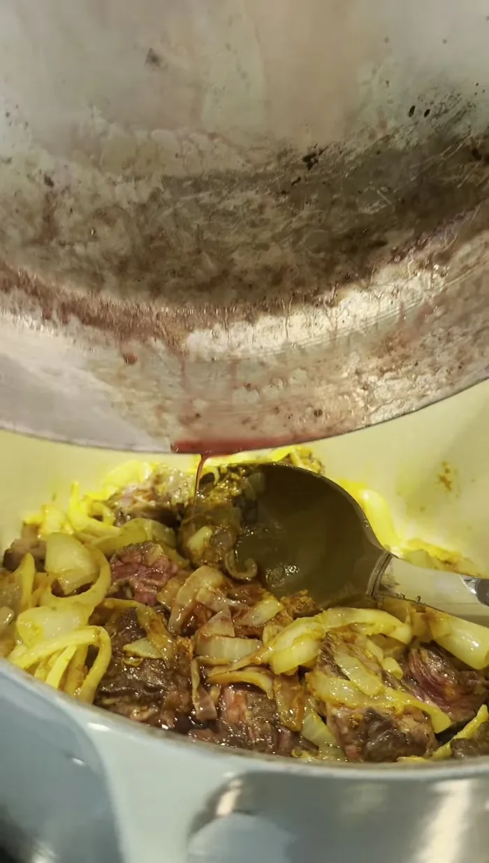 Add wine (deglaze the pan), beef stock, and stir.