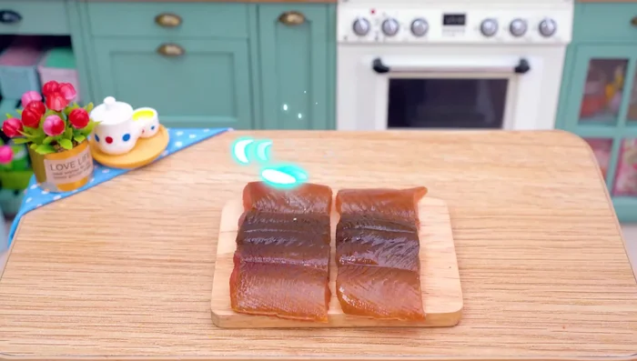 Prepare the eel. Skewer it onto a stick.