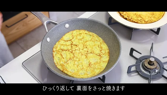 Pour a ladle of batter onto the hot pan, swirling to spread it thinly.