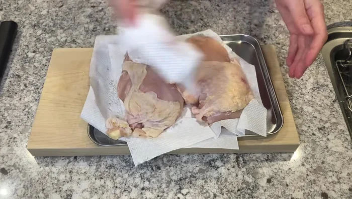 Pat chicken dry with paper towels. Remove any blood clots or yellow stains. Cut into bite-sized pieces, slicing at an angle to create a soft texture.