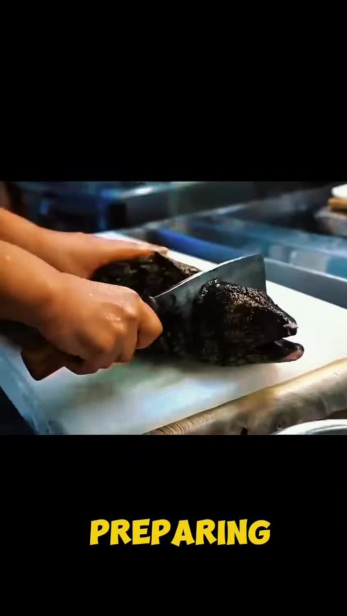 Hook the live eel through the head and suspend it with a cut in its tail. Allow the blood to drain slowly for 30 minutes.
