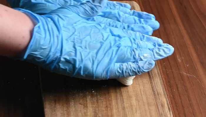 Shape the dango: Cut the dough in half, roll into cylinders, and cut into 20 pieces. Roll each piece into a ball and press the center to create a dent.