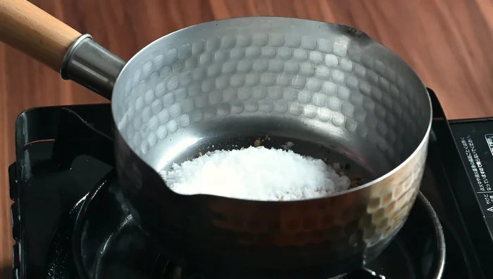 Make the komitsu (brown sugar syrup): In a small pan, combine dark brown sugar, white sugar, and water. Mix, then heat over medium, stirring to dissolve sugar lumps. Once melted and gently bubbling, stop stirring and let it thicken, swirling occasionally.
