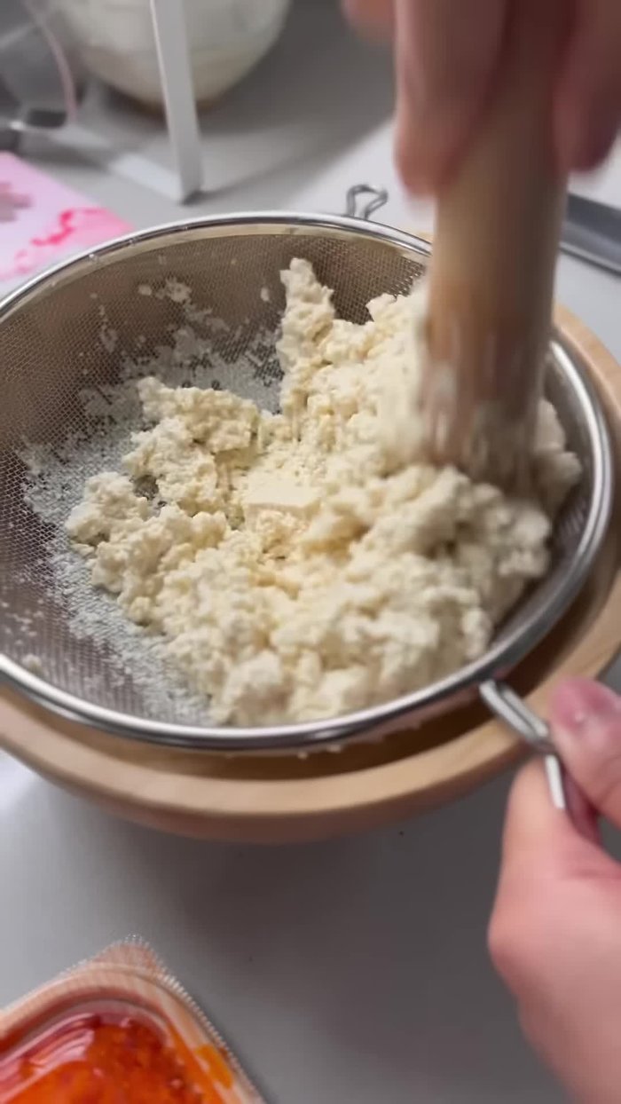 Sift a block of firm tofu through a strainer into a bowl. Make sure to drain all the water from the tofu before you begin mixing.