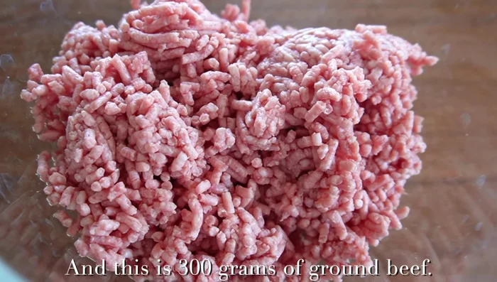 In a bowl, mix the breadcrumbs and milk. Add the ground beef, salt, black pepper and mix until sticky. This step is crucial for a juicy hamburger steak; it helps connect the meat proteins.